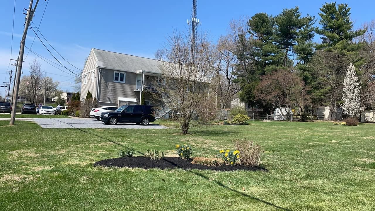 A freshly maintained lawn and landscaped planting beds